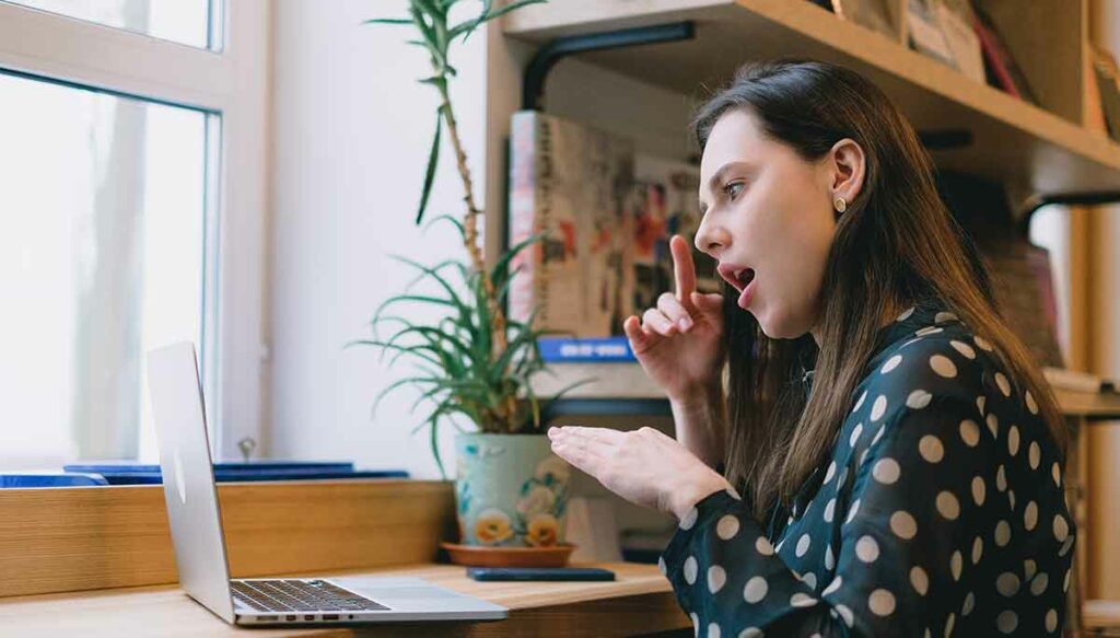 A HIPAA-certified ASL interpreter signs for a patient during a telehealth appointment.