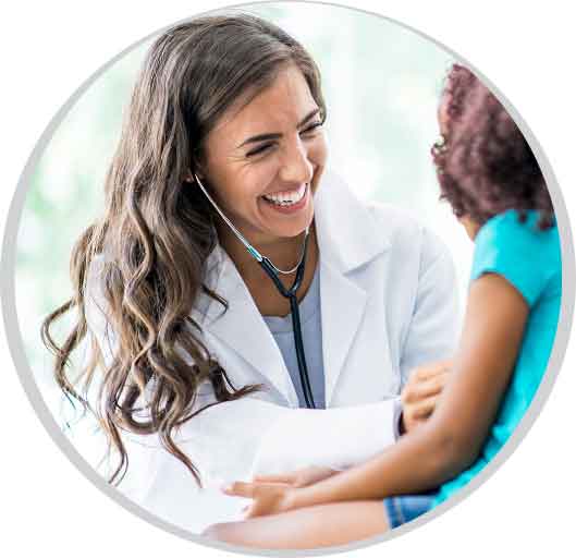 Smiling female provider using  a stethoscope to listen to a child's heartbeat.