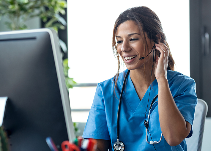 A doctor takes a telehealth call from a new patient with the help of a video interpreter.