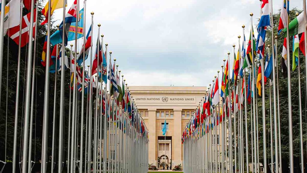 Flags from different countries line the walkway to the United Nations building.