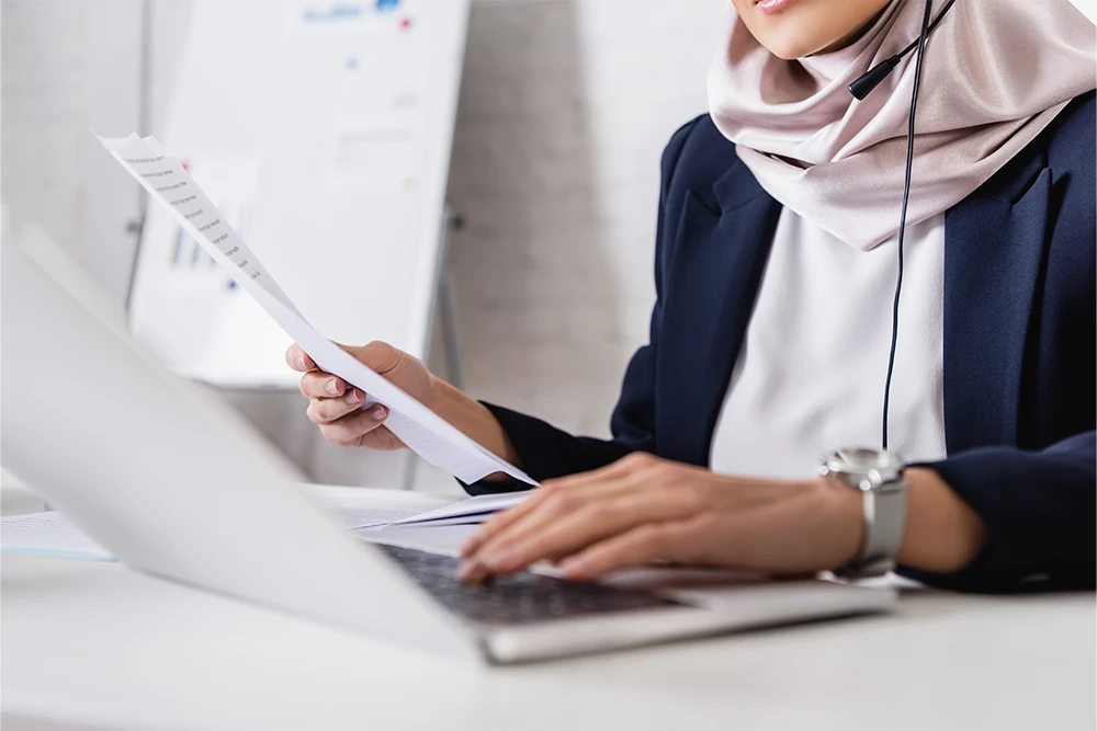 An experienced translator references a customer glossary while working on a new handbook translation project.