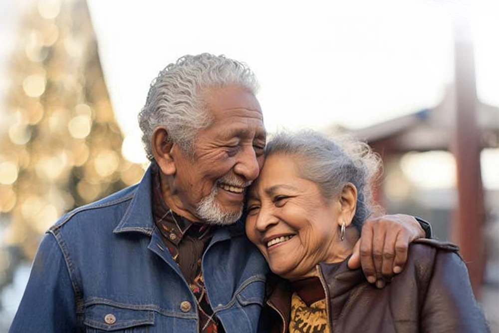 A happy older couple participate in a community volunteer event with the help of interpreters.