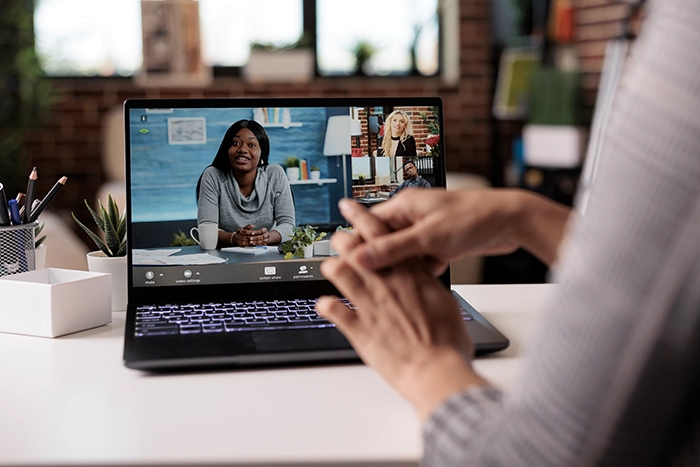 An American Sign Language interpreter signs for a family during a telehealth appointment.